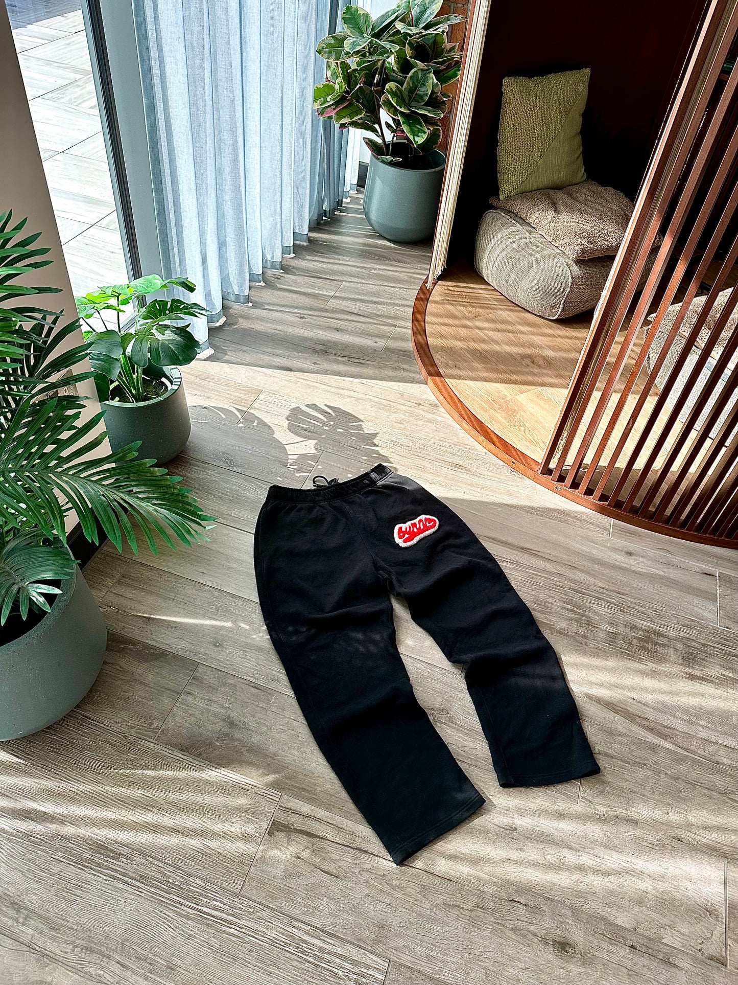 Black and red burnr rug joggers